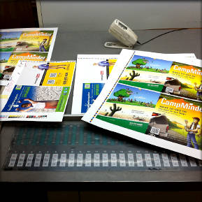The first pages of the CampMinder magazine being reviewed for accuracy